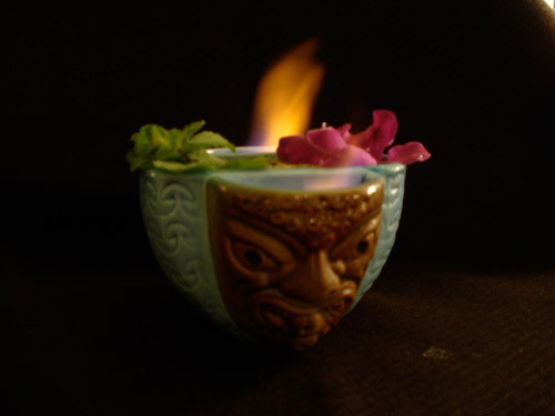 flaming drink in tiki mug